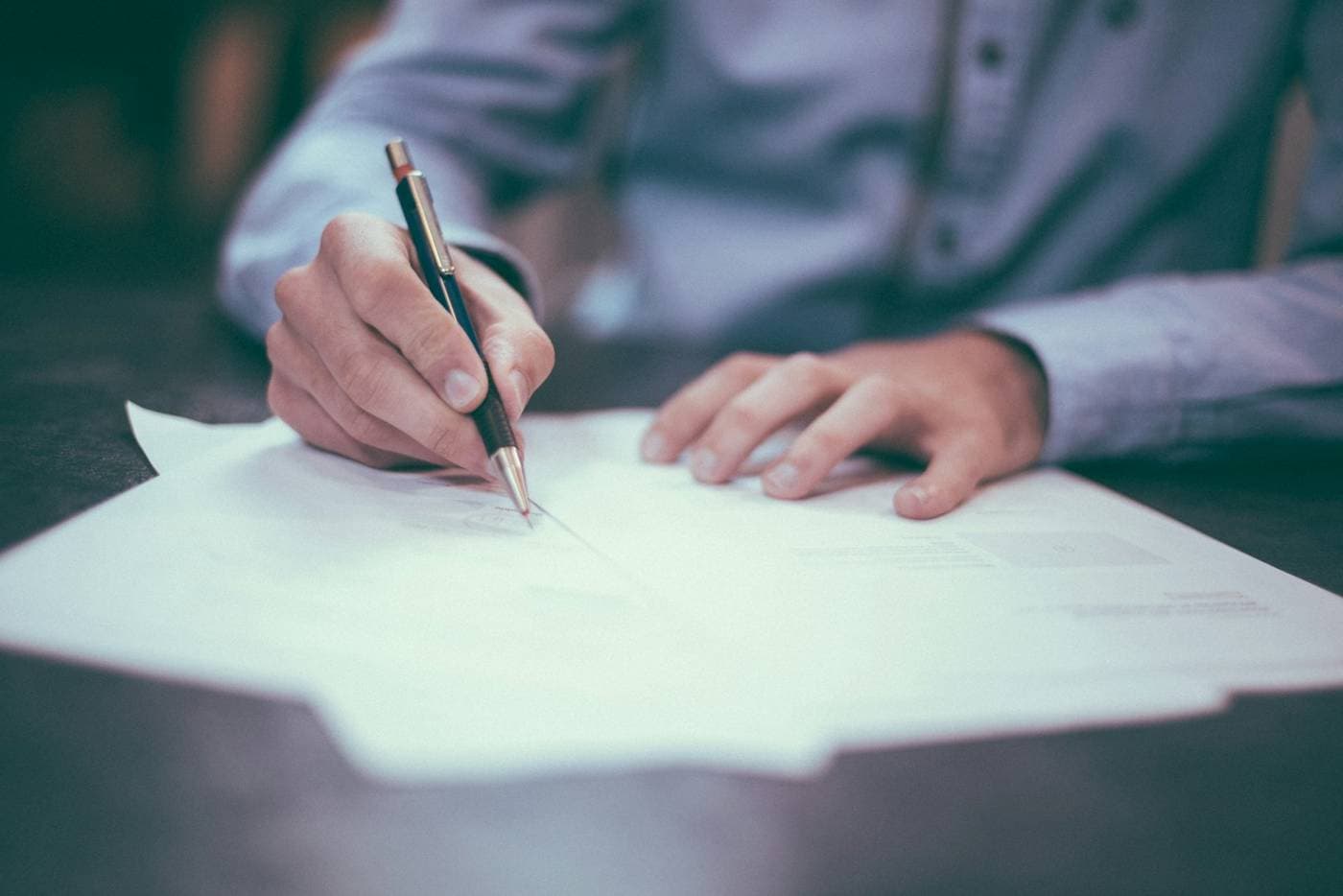 Hand signing a document