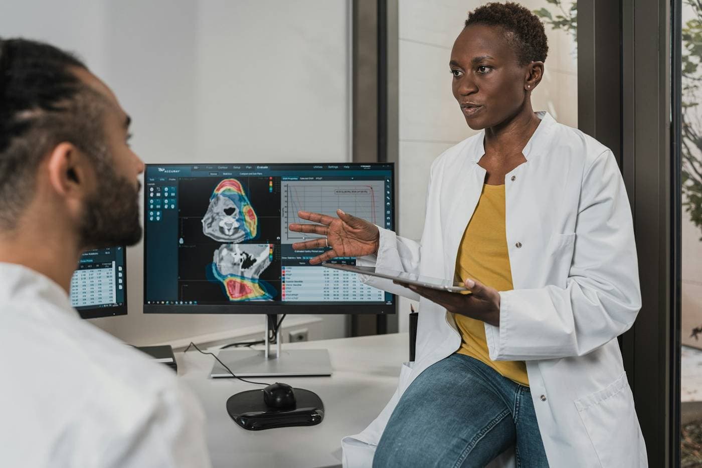Specialists reviewing imaging on a screen